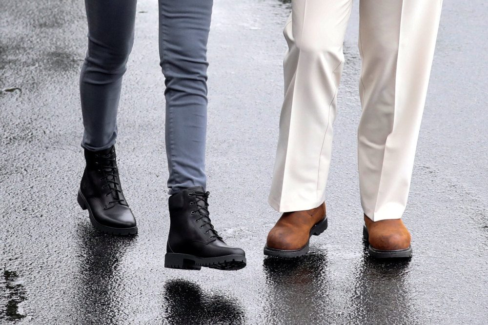 US President Donald Trump and first lady Melania Trump wear boots as they head out together to tour hurricane damage in Florida from White House, October 15, 2018. Reuters/Jonathan Ernst 