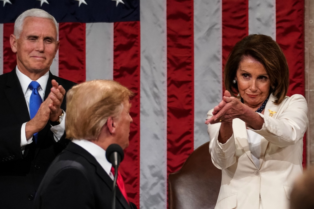 US President Donald Trump arrives to deliver the State of the Union address, alongside Speaker of the House Nancy Pelosi and Vice President Mike Pence,at the US Capitol in Washington, DC, on February 5, 2019. / AFP / pool / Doug Mills 