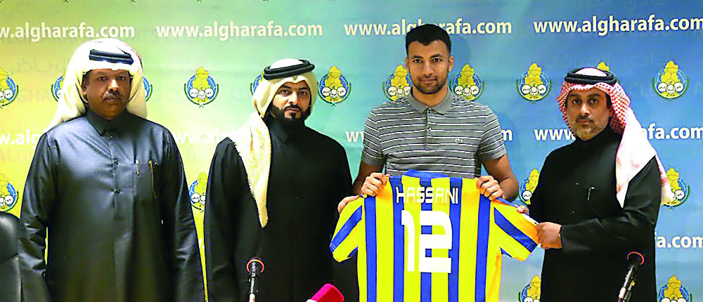 Al Gharafa’s new signing Elias Hassani (third, right) displays his jersey as he poses for a group photo along with officials of the club. 