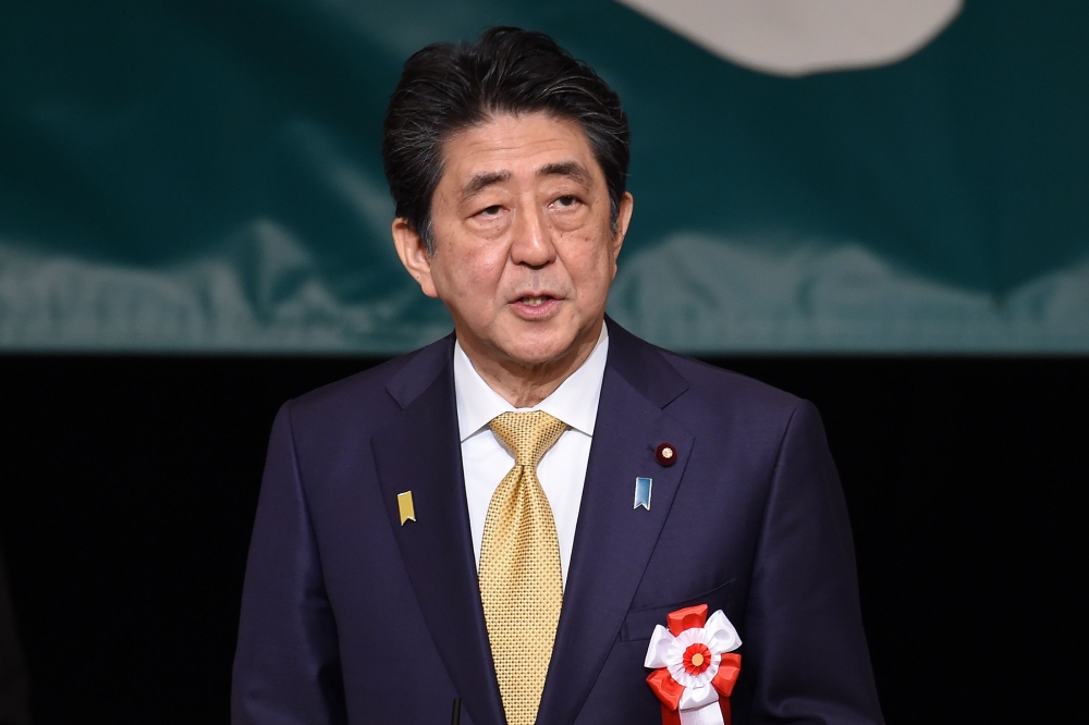 Japan's Prime Minister Shinzo Abe delivers a speech to demand the return of the Northern Territories, a group of islands held by Russia, at a national rally in Tokyo on February 7, 2019.  / AFP / Kazuhiro NOGI