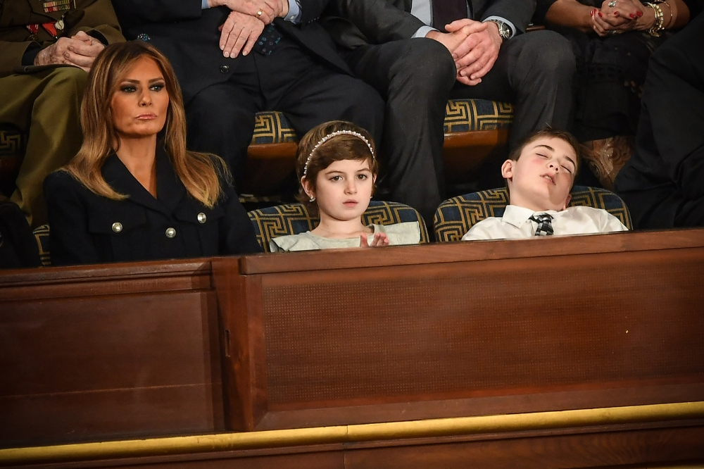 First lady Melania Trump (L) with Grace Eline and Joshua Trump, special guests of President Donald Trump, attend the State of the Union address at the US Capitol on February 5, 2019.  AFP / Mandel Ngan