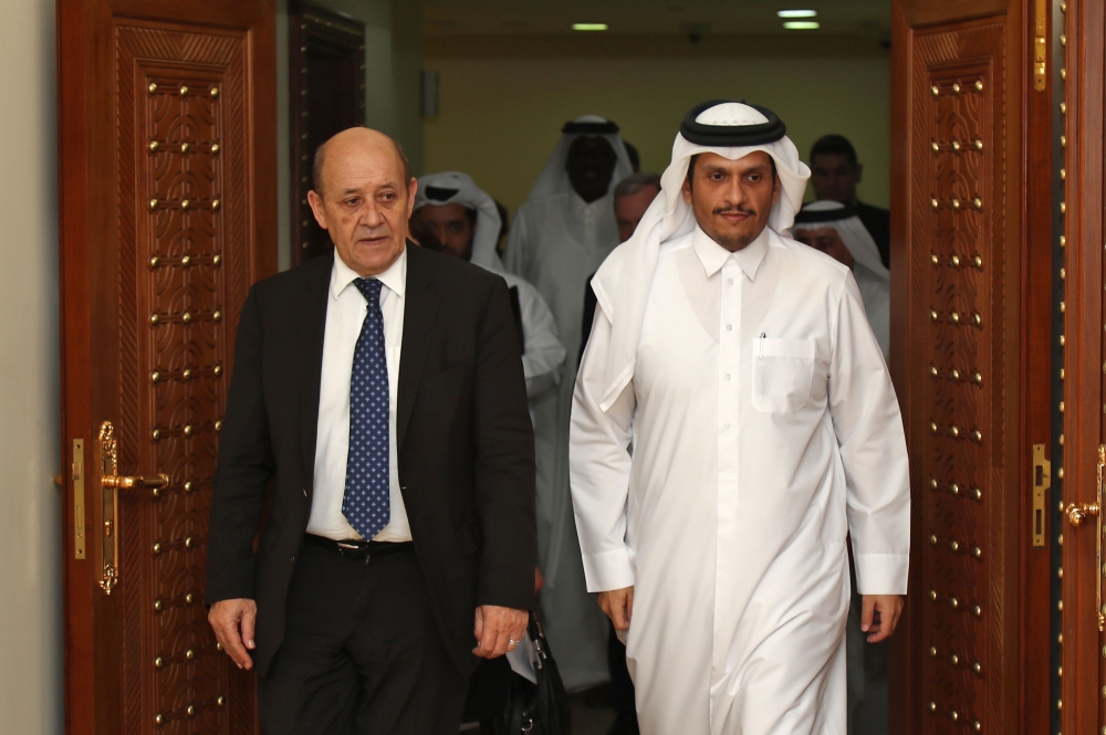 Qatar Deputy Prime Minister and Minister of Foreign Affairs HE Sheikh Mohamed bin Abdulrahman Al Thani (R), and Foreign Minister walks alongside his French counterpart Jean-Yves Le Drian in Doha on February 11, 2019. / AFP / KARIM JAAFAR
