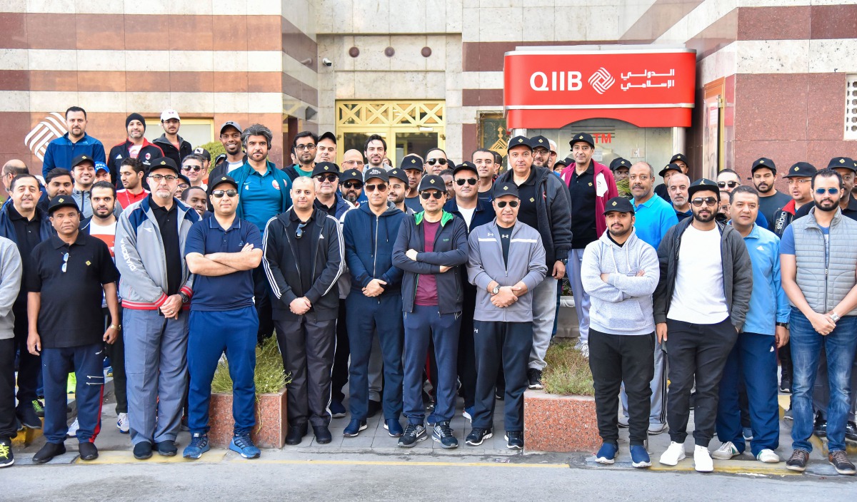 Dr Abdulbasit Ahmad Al Shaibei, Chief Executive Officer of QIIB, and other senior executives and employees of the Bank posing for a group picture while participating at this year’s National Sport Day yesterday.