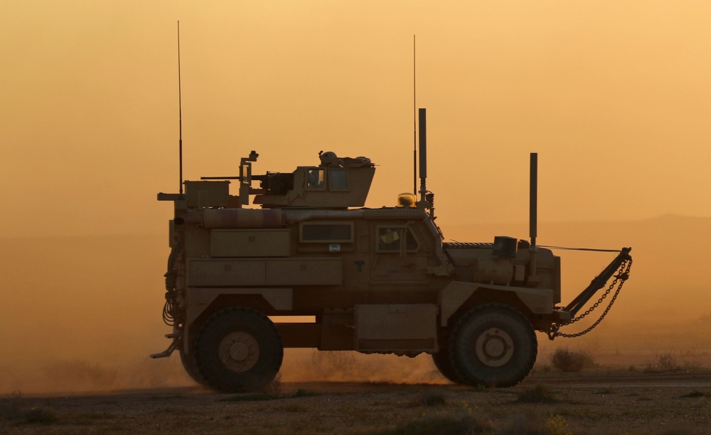 A military vehicle with the US-backed Syrian Democratic Forces (SDF) rides during an operation to expel Islamic State group (IS) jihadists from the Baghouz area in the eastern Syrian province of Deir Ezzor on February 13, 2019. (AFP / Delil souleiman)