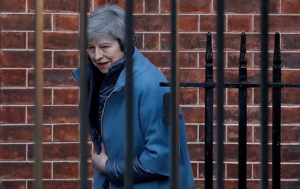 Britain's Prime Minister Theresa May leaves from the rear of 10 Downing Street in London on February 14, 2019 ahead of a vote on amendments to the Brexit withdrawal bill. AFP / Tolga Akmen 