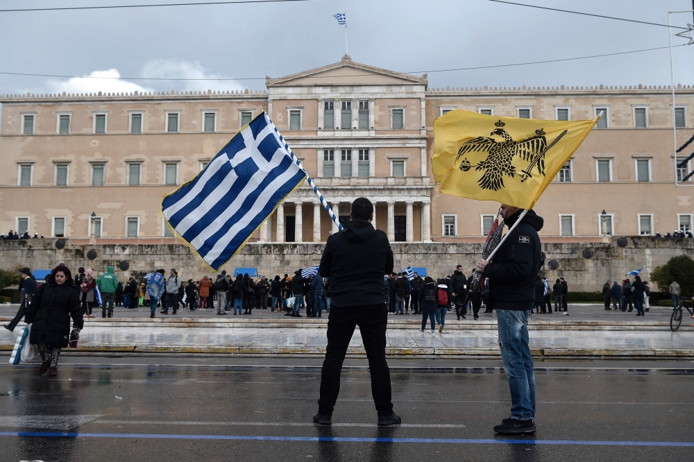 Protesters stand in front of the Greek Parliament in Athens on January 25, 2019. AFP / Louisa Gouliamaki