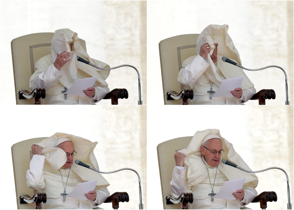 A combination photo shows a gust of wind blowing the mantle Pope Francis during the Wednesday general audience in Saint Peters square at the Vatican, May 16. 2018. Reuters/Max Rossi
