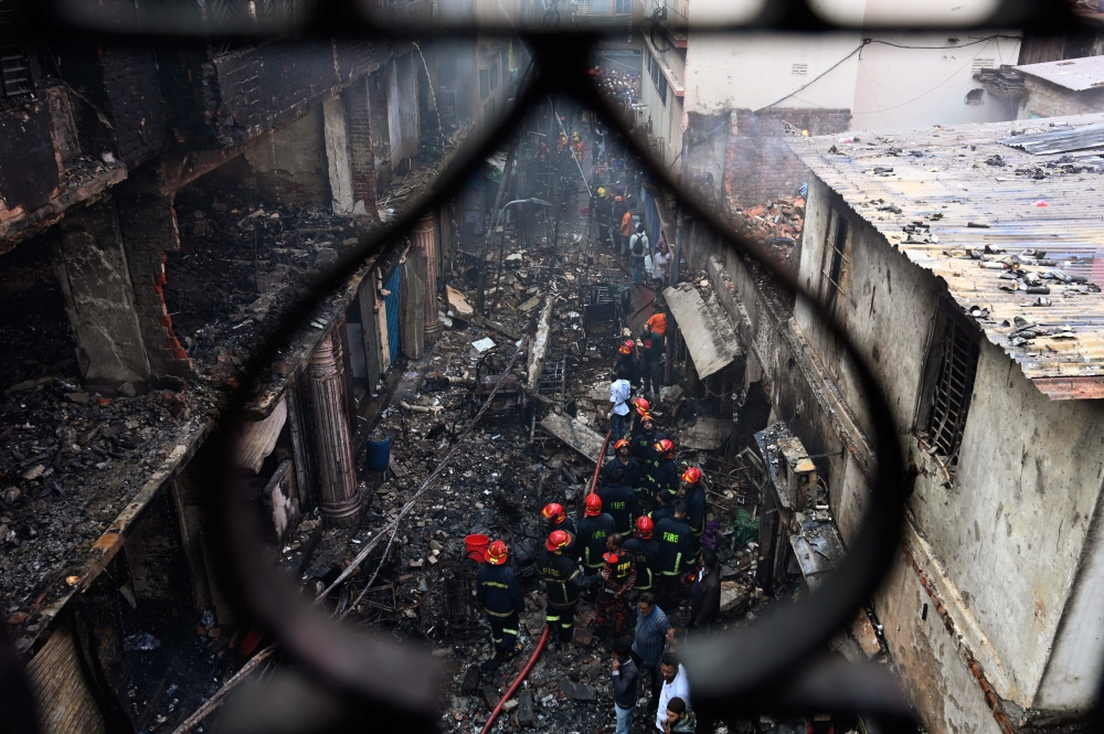 Firefighters are seen at the scene of a fire in Dhaka on February 21, 2019. AFP / Munir UZ ZAMAN