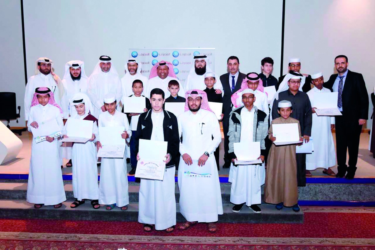 The officials of QIB with the winners of the Holy Quran recitation contest organised by Ahmed Bin Mohamed Secondary School for Boys. 