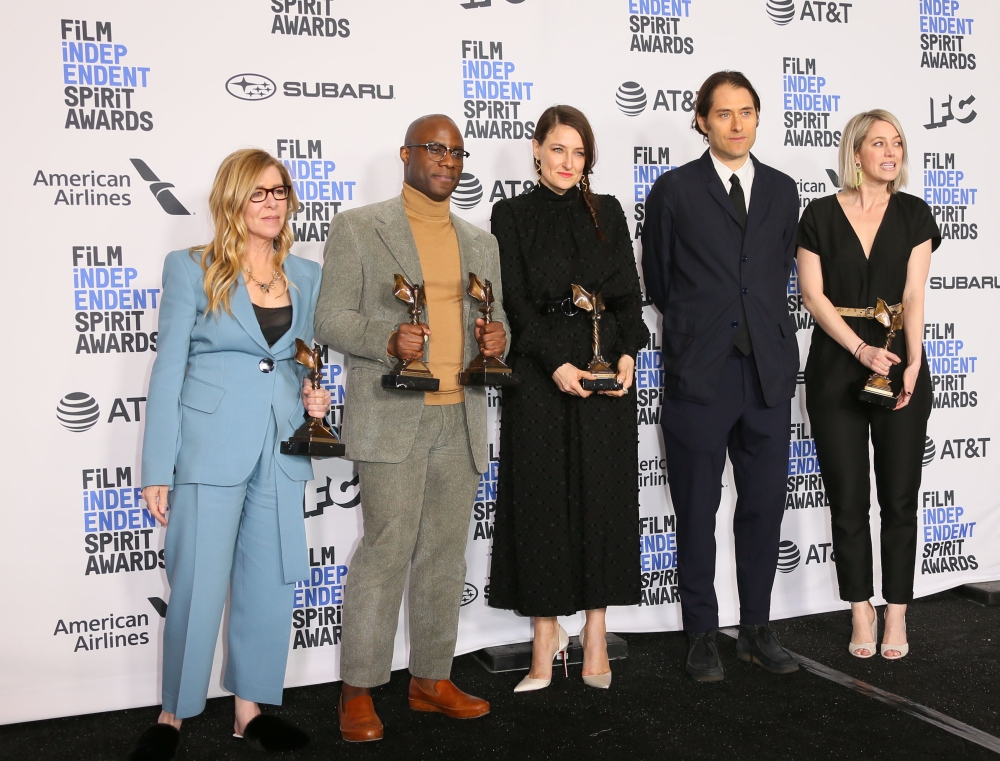 Barry Jenkins (2L) holds the awards for Best Director and Best Feature alongside the cast of 