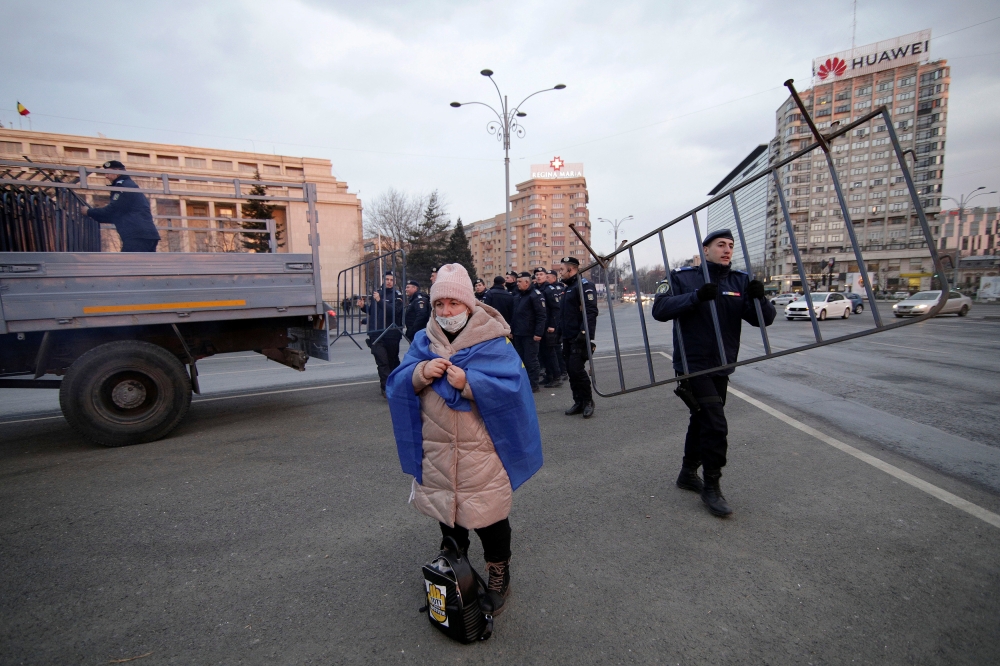 A woman, wrapped in a European Union flag takes part in a demonstration against judicial changes in Bucharest, Romania, February 24, 2019. Inquam Photos/George Calin via Reuters  