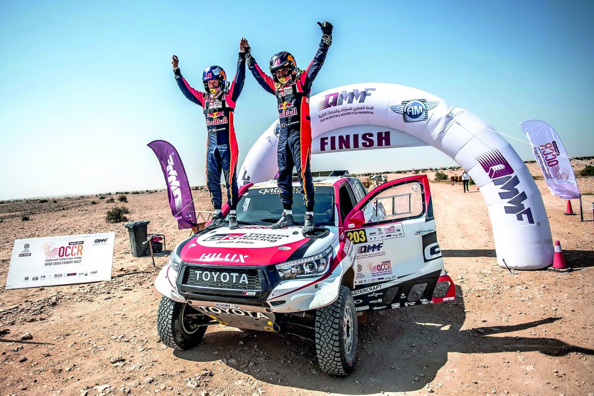 Qatar’s Nasser Saleh Al Attiyah and his navigator Matthieu Baumel celebrate after winning the Manateq Qatar Cross-Country Rally, the opening round of the FIA World Cup for Cross-Country Rallies, yesterday.