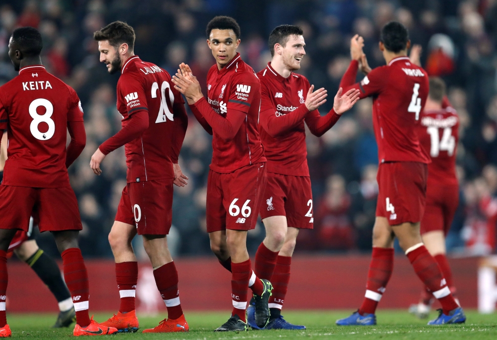Liverpool's Trent Alexander-Arnold and team mates celebrate after the match REUTERS/Russell Cheyne 