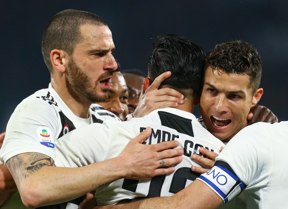 Juventus' Portuguese forward Cristiano Ronaldo (R) celebrates with his teammates his side's second goal during the Italian Serie A football match between Napoli and Juventus on March 3, 2019, at the San Paolo Stadium in Naples. / AFP / CARLO HERMANN