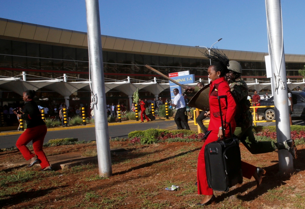 Kenya Airways workers are dispersed by riot police officers at the Jomo Kenyatta International Airport during a labour dispute that grounded flights near Nairobi, Kenya March 6, 2019. REUTERS/Thomas Mukoya