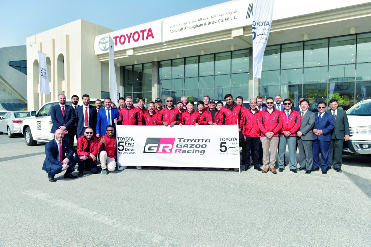 Officials posing for a group photo with the members of the TOYOTA GAZOO Racing in Doha.