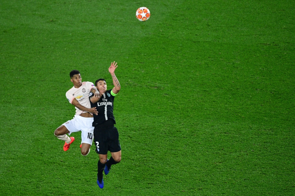 Manchester United's English forward Marcus Rashford (L) fights for the ball with Paris Saint-Germain's Brazilian defender Thiago Silva during the UEFA Champions League round of 16 second-leg football match between Paris Saint-Germain (PSG) and Manchester 