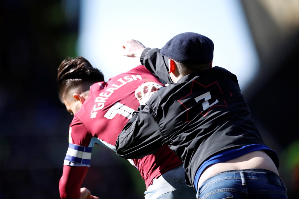 A fan invades the pitch and attacks Aston Villa's Jack Grealish during the match Action Images via Reuters/Carl Recine