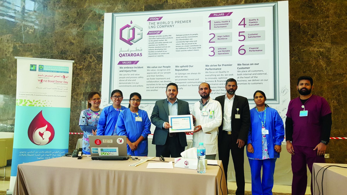  Qatargas employees pose for a group photo at Qatargas headquarters in Doha. 