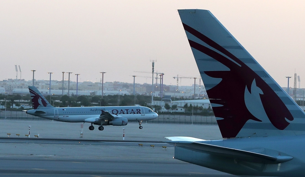A Qatar Airways plane lands at the Hamad International Airport in Doha in this photo taken on June 12, 2017. AFP/Karim Jaafar