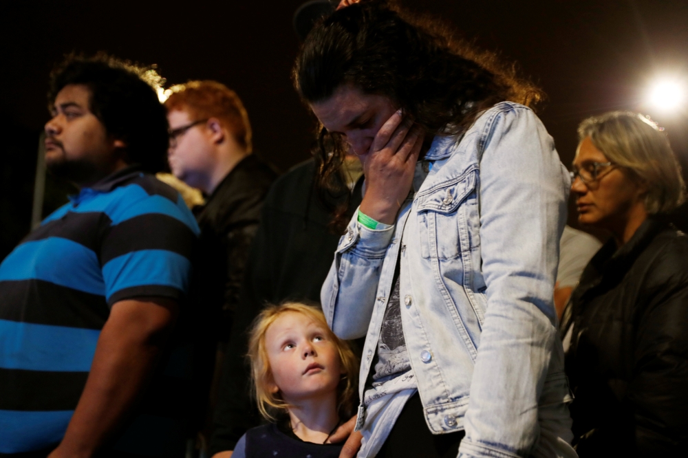 A woman reacts as she pays a tribute to victims of the mosque attacks outside Masjid Al Noor in Christchurch, New Zealand, March 16, 2019. REUTERS/Jorge Silva