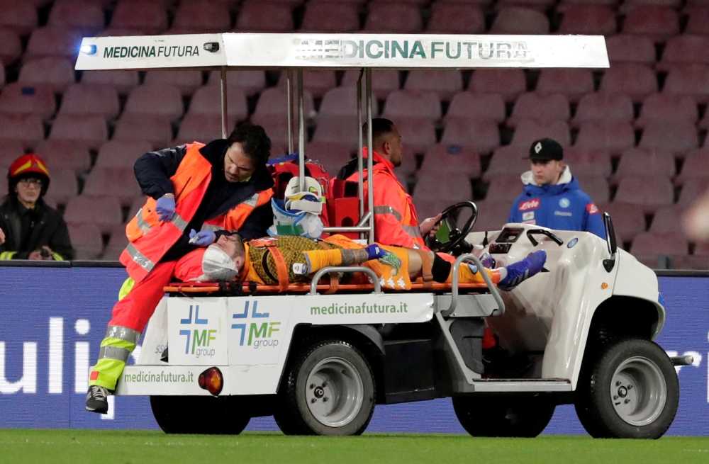 Napoli's David Ospina is stretchered off the pitch after sustaining an injury. Reuters/Ciro De Luca
 