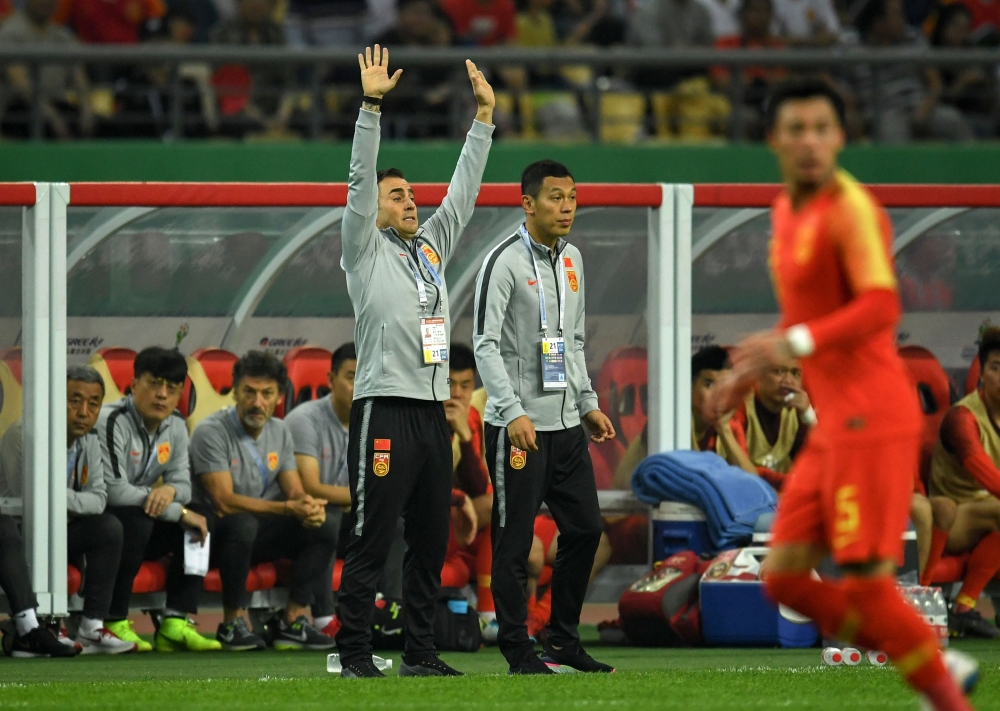 China's new head coach Fabio Cannavaro (L) gestures during the 2019 China Cup football match between China and Thailand in Nanning, in China's southern Guangxi region, on March 21, 2019. China OUT / AFP / STR