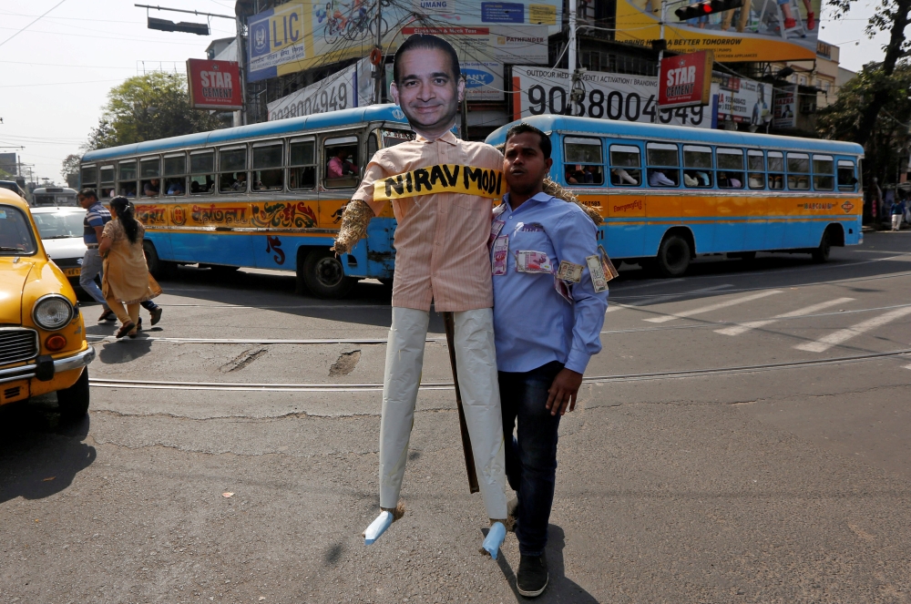A demonstrator holds an effigy depicting billionaire jeweller Nirav Modi during a protest in Kolkata, India, February 18, 2018. Reuters/Rupak De Chowdhuri