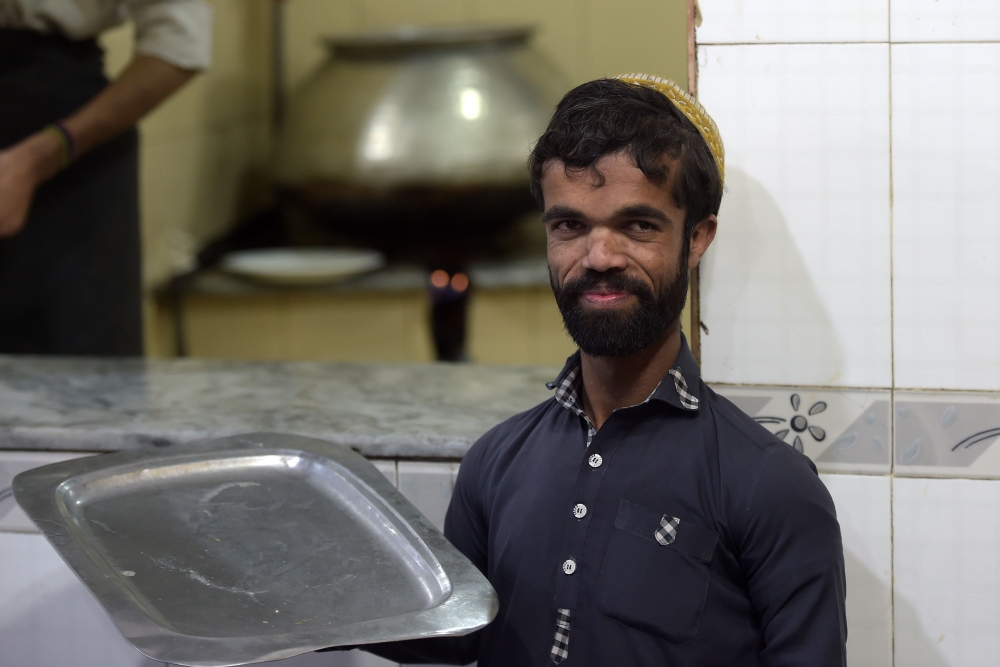 In this picture taken on February 22, 2019, Rozi Khan, a 25-year-old Pakistani waiter who resembles US actor Peter Dinklage, looks on at Dilbar Hotel in Rawalpindi. AFP/Aamir Qureshi 