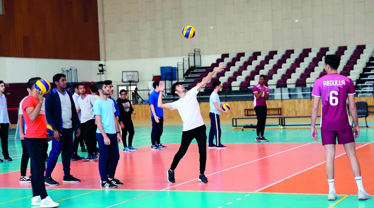 Team Qatar’s volleyball team interacting with students of the American Academy School at Al Arabi Sports Club Stadium in Doha.