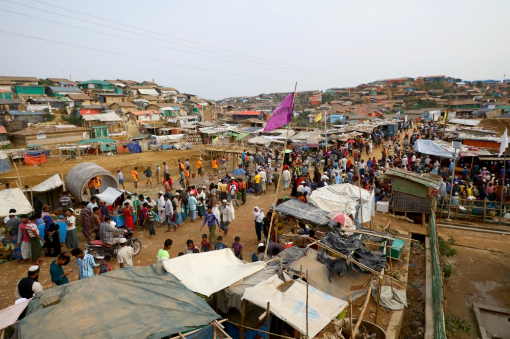 FILE PHOTO: Rohingya refugees gather at a market inside a refugee camp in Cox's Bazar, Bangladesh, March 7, 2019. REUTERS/Mohammad Ponir Hossain