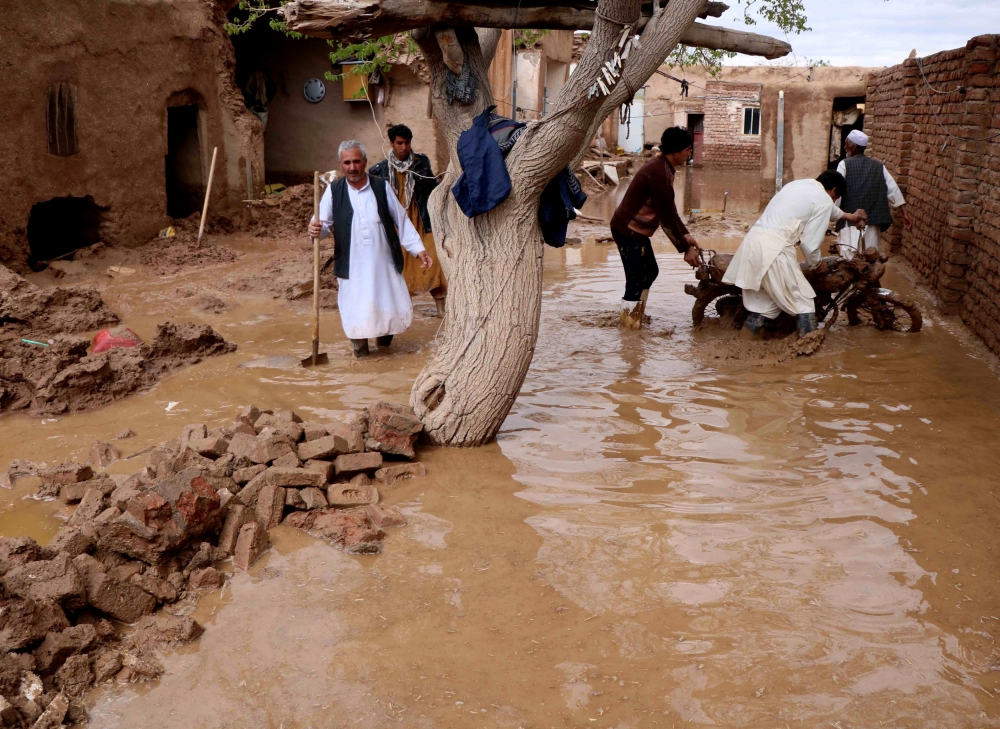 People salvage items from a house destroyed by flood in Enjil district of Herat province, Afghanistan March 29, 2019. Picture taken March 29, 2019.REUTERS/Jalil Ahmad