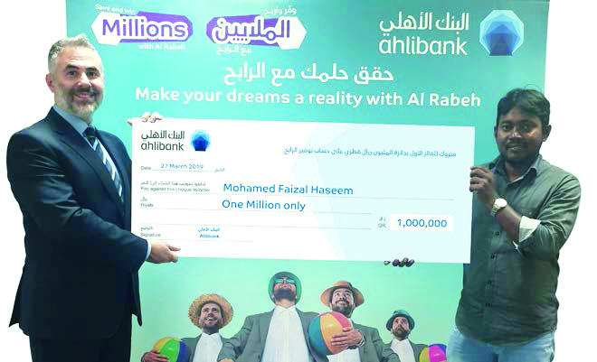 Mohamed Faizal Haseem (right), the winner of Ahlibank’s Al Rabeh Savings Scheme first draw for QR1m prize for March 2019, receiving the presentation cheque from a senior official of the bank. 