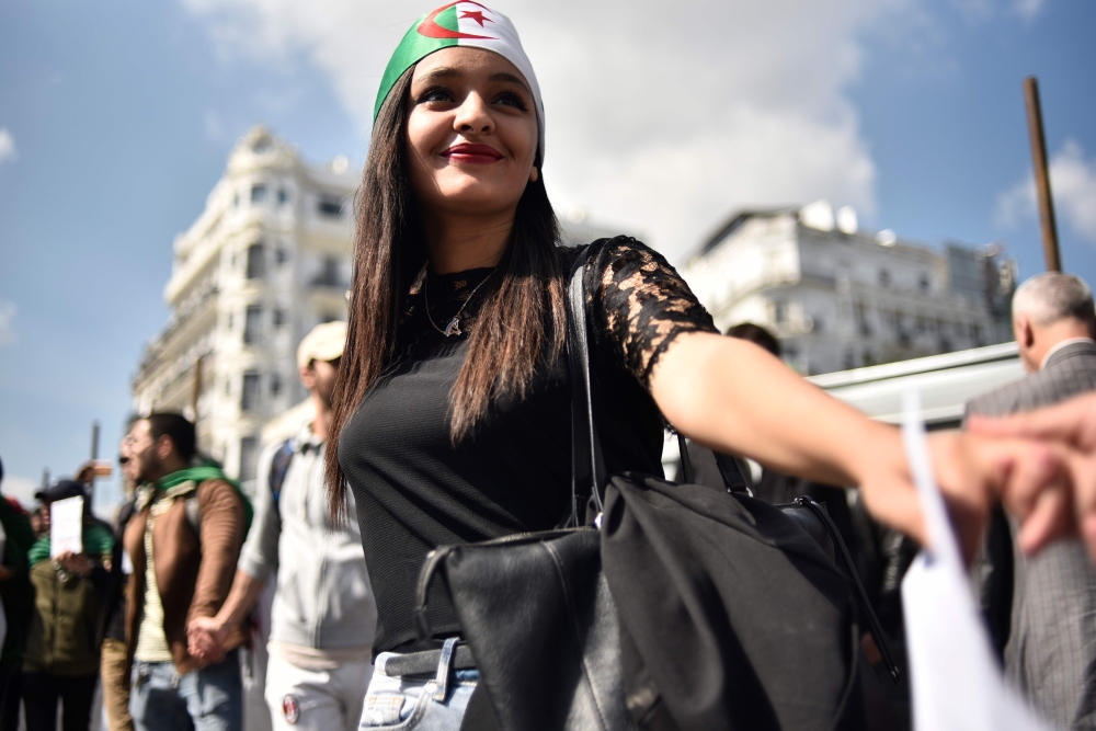 Algerian students raise banners and placards as they take part in a demonstraion against the current government in the capital Algiers on April 2, 2019.  AFP / RYAD KRAMDI