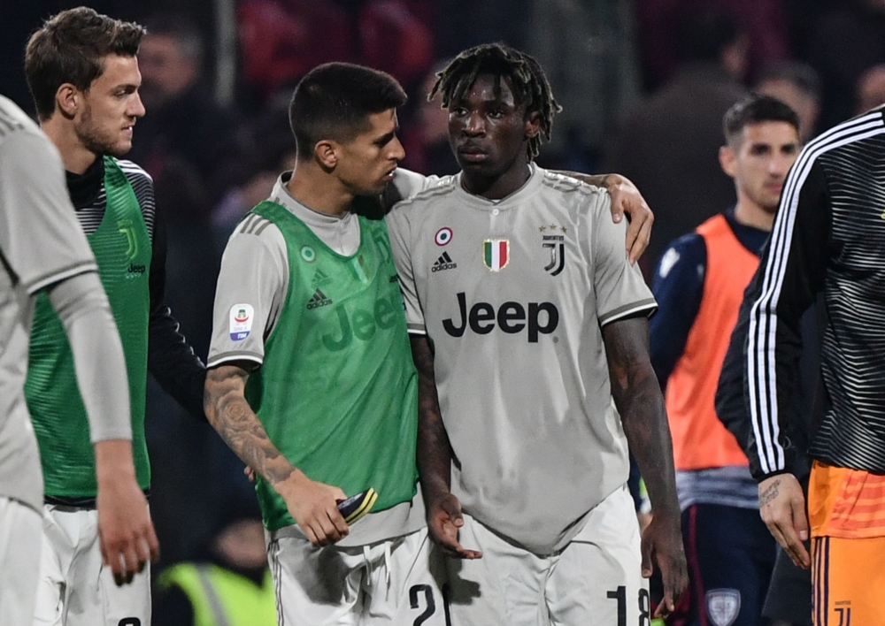 Juventus' Portuguese defender Joao Cancelo (C-L) comforts Juventus' Italian forward Moise Kean at the end of the Italian Serie A football march Cagliari vs Juventus on April 2, 2019 at the Sardignia Arena in Cagliari, after Cagliari's fans threw projectil