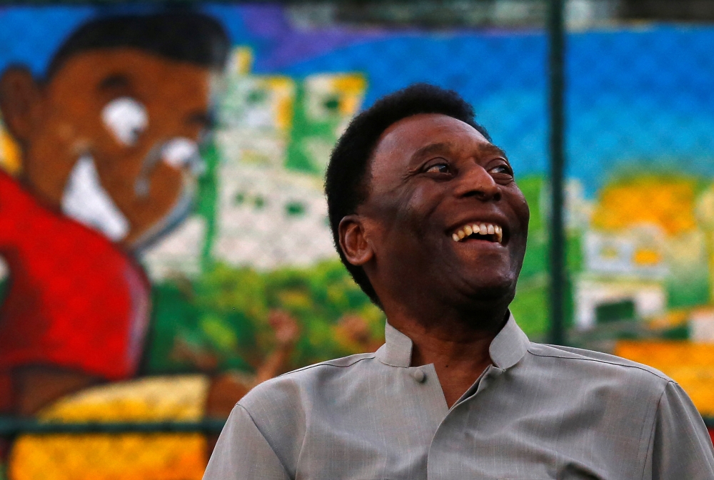 Brazilian soccer legend Pele laughs during the inauguration of a refurbished soccer field at the Mineira slum in Rio de Janeiro, Brazil September 10, 2014. Reuters/Ricardo Moraes