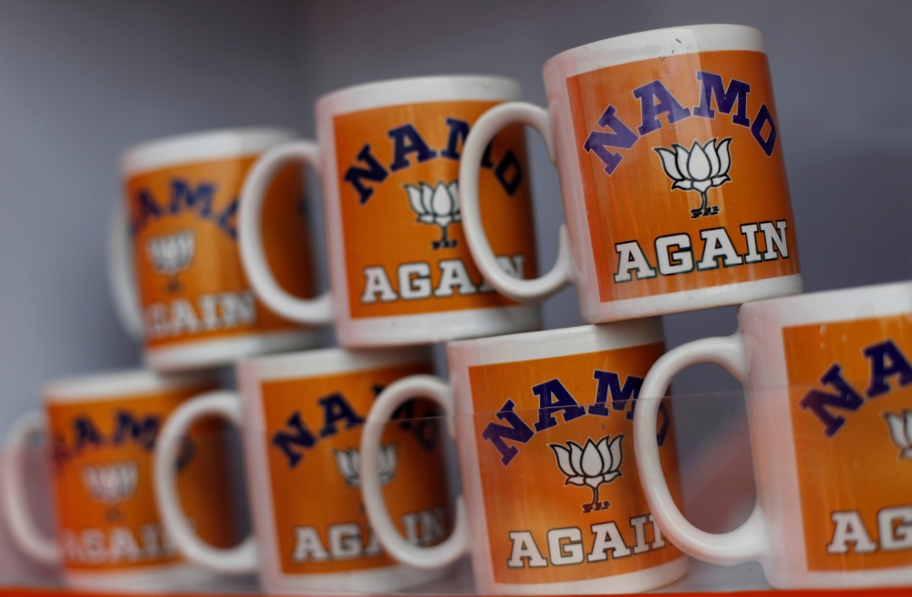 FILE PHOTO: Mugs featuring India's ruling Bharatiya Janata Party (BJP) are on display for sale outside the venue of an election rally addressed by Prime Minister Narendra Modi in Meerut in the northern Indian state of Uttar Pradesh, India, March 28, 2019.