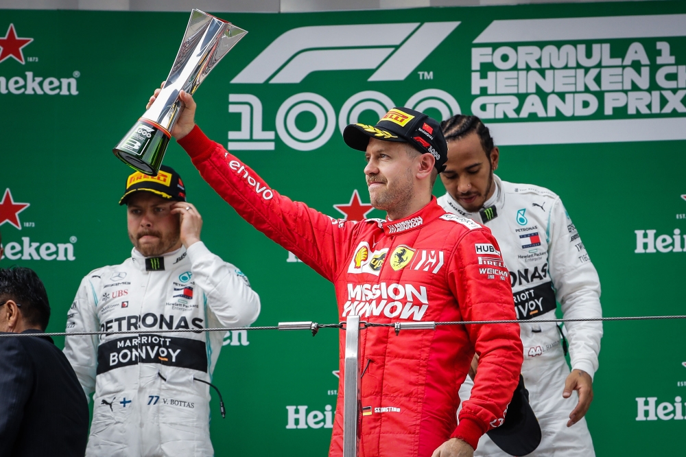 German driver Sebastian Vettel (C) of Ferrari celebrates on the podium after placing third in the F1 Grand Prix of China at Shanghai International Circuit on April 14, 2019 in Shanghai, China. Stringer - Anadolu 
