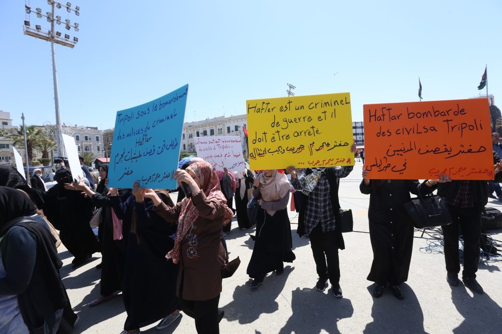Women carry banners during a funeral ceremony for those, who died in rocket attacks by East Libya-based forces led by commander Khalifa Haftar at the Abu Salim neighborhood, at Martyrs' Square in Tripoli, Libya on April 17, 2019. (Hazem Turkia/Anadolu Age