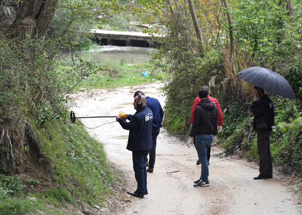 Forensic team search for evidence near the village of Rinas near Tirana on April 10, 2019 at the place where police clashed with robbers who stole millions of euros from Austria Airlines plane. AFP/Gent Shkullaku