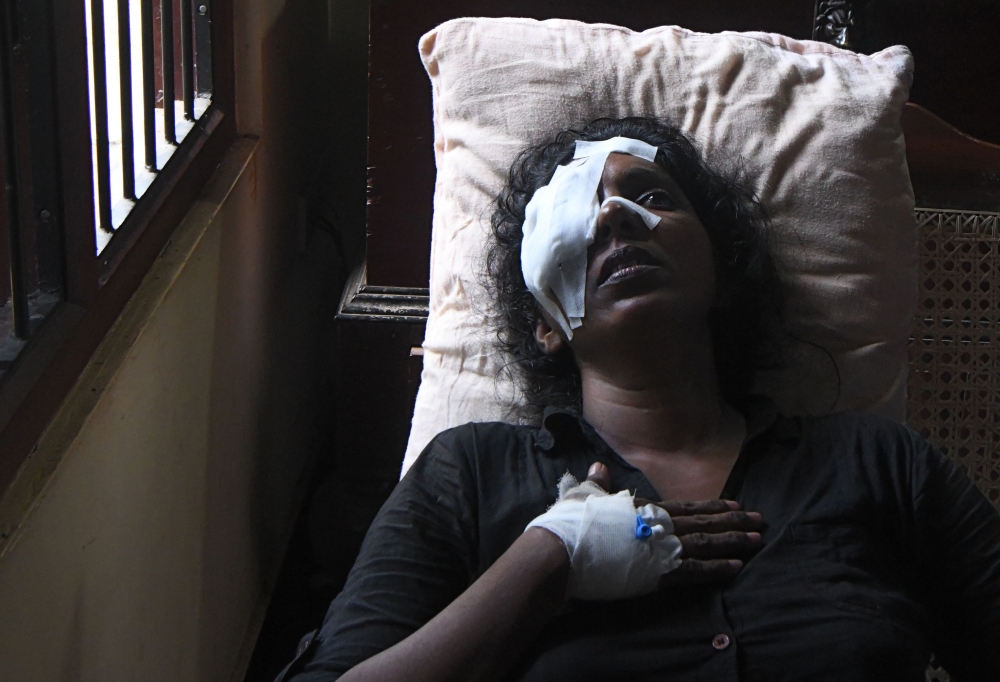  Anusha Kumari 43, wife of a St Sebastian's Church suicide blast victim Dulip Appuhami, 46, reacts as she cries in her house in Negombo on April 24, 2019.  AFP / Lakruwan Wanniarachchi  

