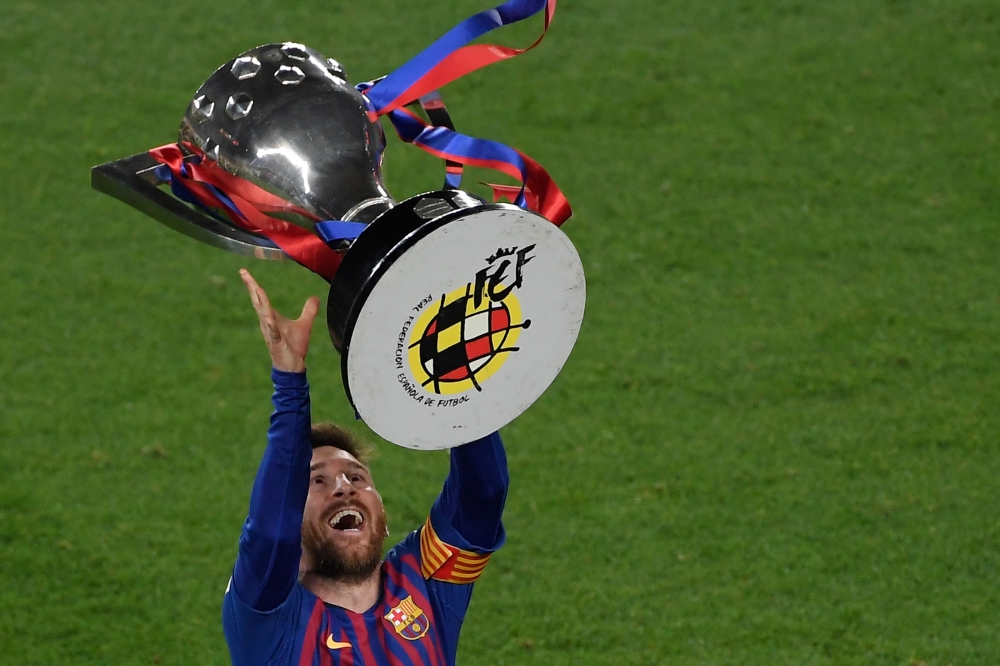 Barcelona's Argentinian forward Lionel Messi raises La Liga trophy as he celebrates becoming La Liga champions after winning the Spanish League football match between FC Barcelona and Levante UD at the Camp Nou stadium in Barcelona on April 27, 2019.  AFP