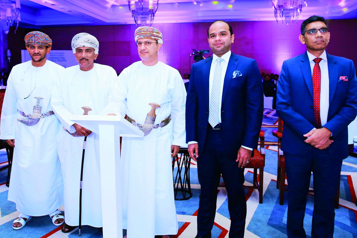Adeeb Ahamed (second left), Managing Director, LuLu Exchange, with other dignitaries, witnessing the unveiling of the new brand name and logo in Muscat on Sunday. 