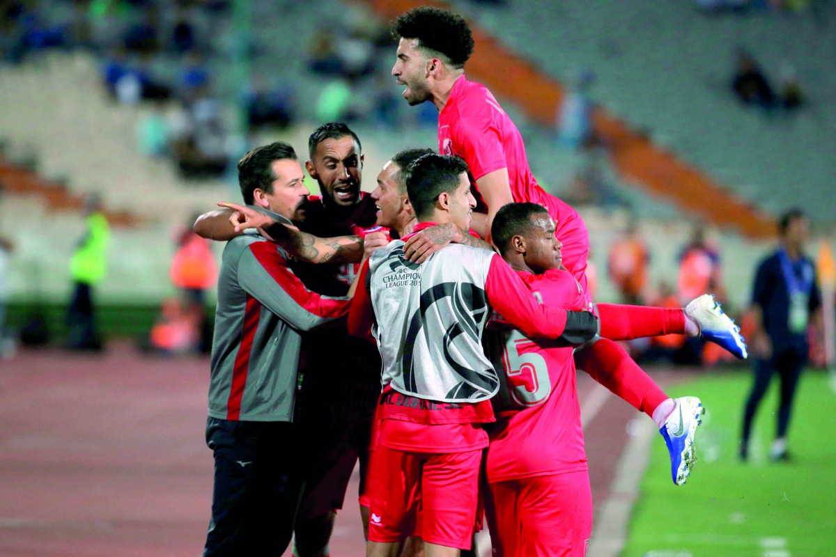 Al Duhail’s midfielder Edmilson Junior (centre) celebrates with team-mates after scoring a goal against Iran’s Esteghlal in their AFC Champions League group C match played in Tehran, yesterday. 