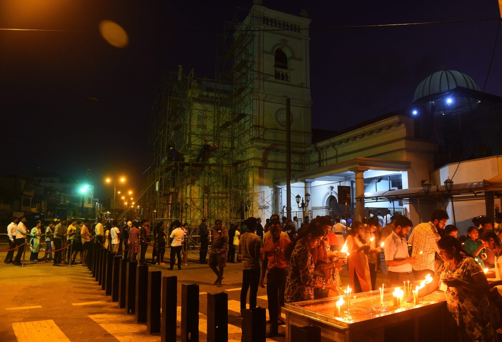 Sri Lankan Catholic devotees pray at St Anthony's church after it was partially opened for the first time since the Easter Sunday attacks in Colombo on May 7, 2019. AFP / ISHARA S. KODIKARA
