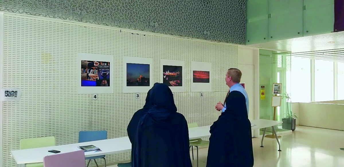 The faculty of ABP taking a look at the photographs at its library as part of the contest. 
