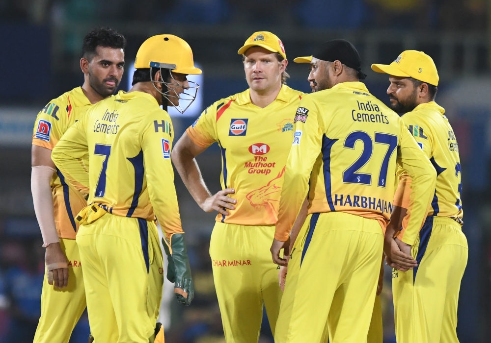 Chennai Super Kings cricketer Harbhajan Singh (2R) celebrates with teammate captain Mahendra Singh Dhoni (L) for the wicket of Delhi Capitals batsman Sherfane Rutherford (unseen) during the 2019 Indian Premier League (IPL) second qualifier Twenty20 cricke