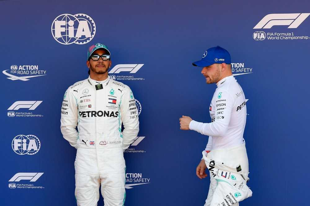 Mercedes' Finnish driver Valtteri Bottas (R) and Mercedes' British driver Lewis Hamilton pose after taking the top two positions following the qualifying session at the Circuit de Catalunya in Montmelo in the outskirts of Barcelona on May 11, 2019 ahead o
