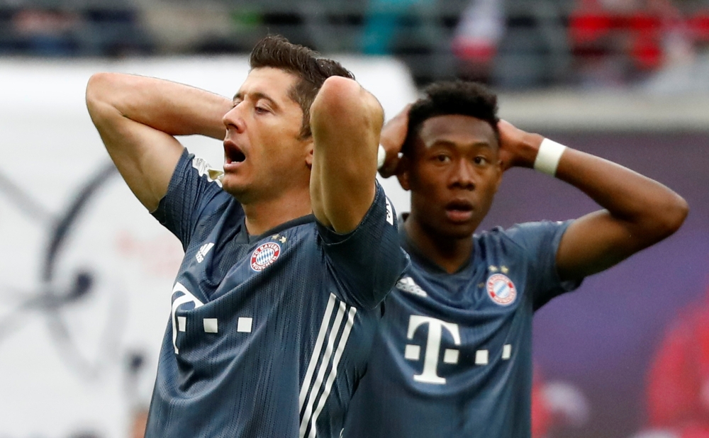 Bayern Munich's Robert Lewandowski and David Alaba react REUTERS/Kai Pfaffenbach