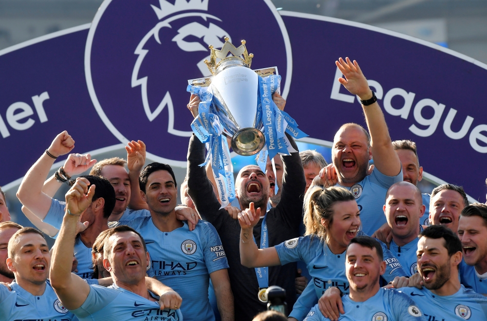 Manchester City manager Pep Guardiola lifts the trophy as they celebrate winning the Premier League REUTERS/Toby Melville 